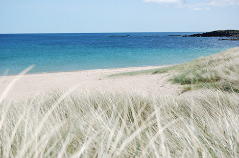 The beautiful blue-green sea and pale sand of Football Hole beach