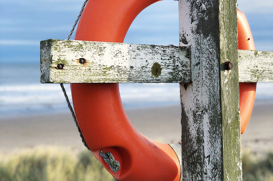 A life buoy nestled in the dunes